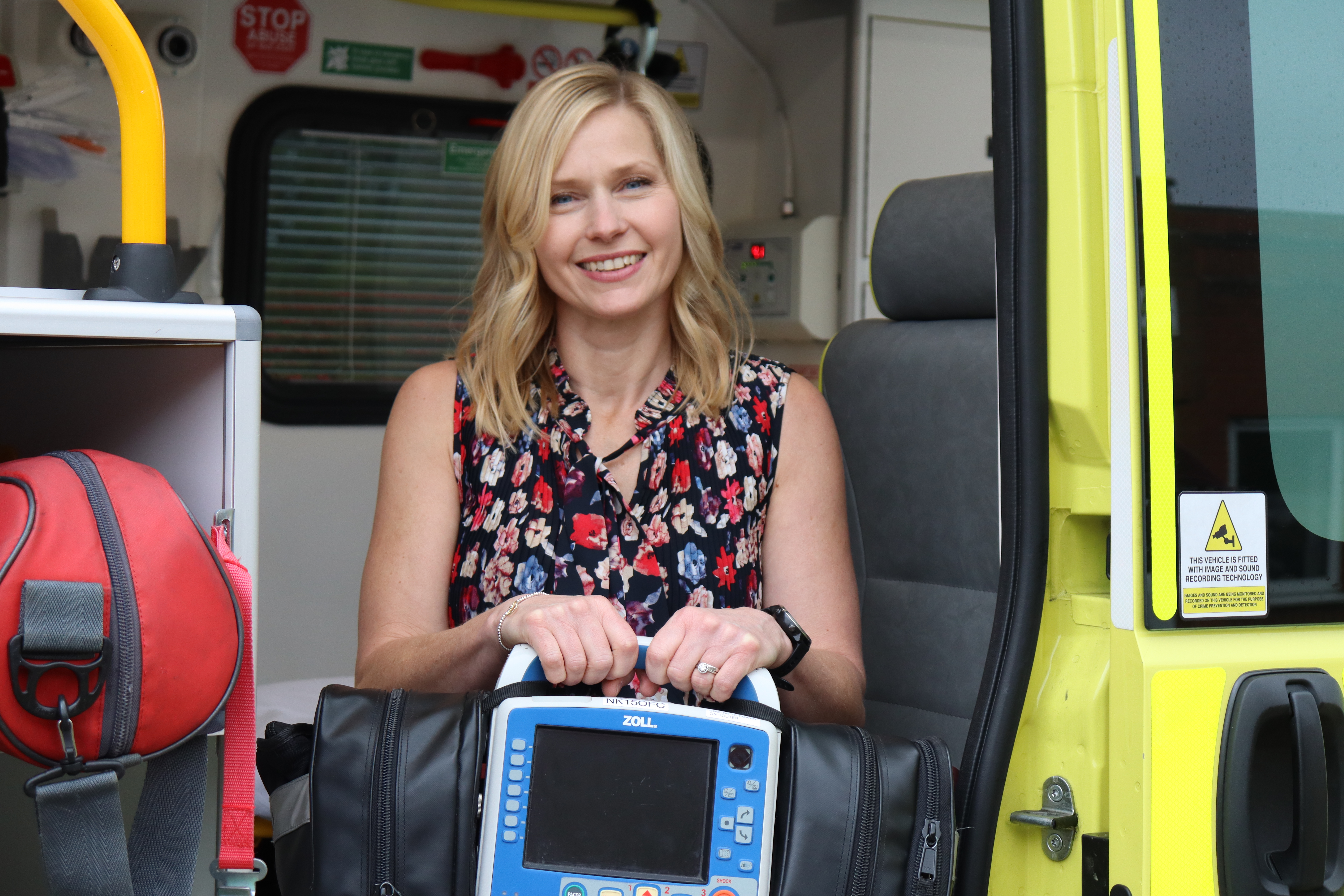 Charlotte with defib - patient reunion.jpg