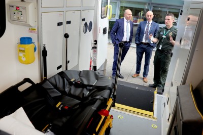 Operations manager Darren Green and Chief Executive Kev Scollay show Sir Jim Mackey around a new electric vehicle (2).jpeg