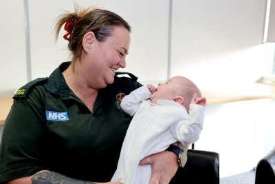 NEAS health advisor Toni Hackett with baby Sebastian, who she helped deliver.jpg